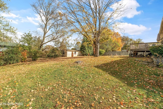 view of yard with fence and a deck