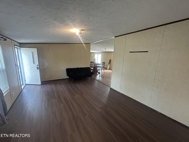 230 Hitch St, Vonore, TN 37885 - unfurnished living room with a textured ceiling and wood finished floors