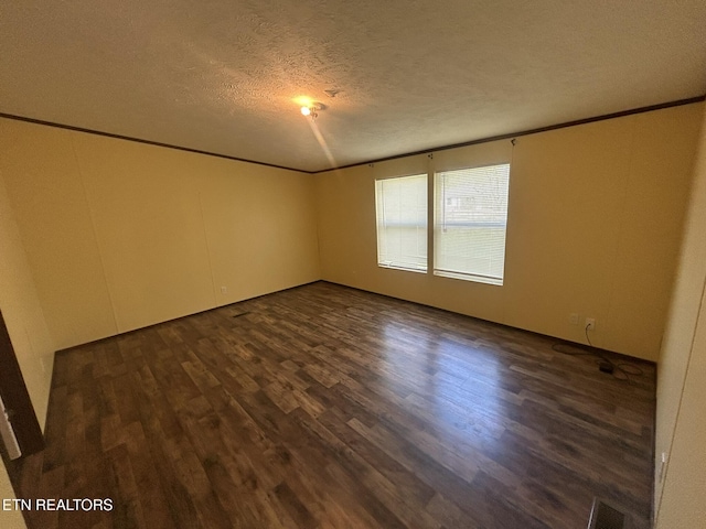 230 Hitch St, Vonore, TN 37885 - empty room with ornamental molding, dark wood-type flooring, a textured ceiling, and visible vents