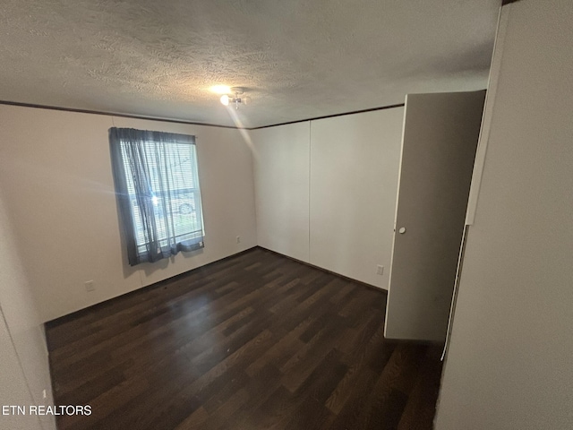 230 Hitch St, Vonore, TN 37885 - unfurnished room featuring dark wood-style floors and a textured ceiling