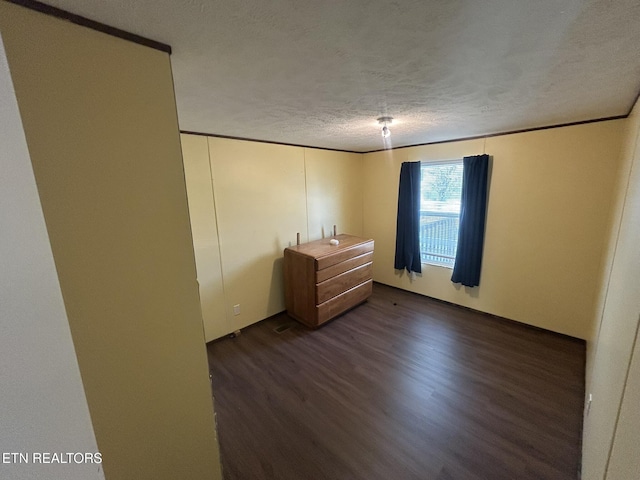 230 Hitch St, Vonore, TN 37885 - unfurnished bedroom featuring dark wood-style floors and a textured ceiling