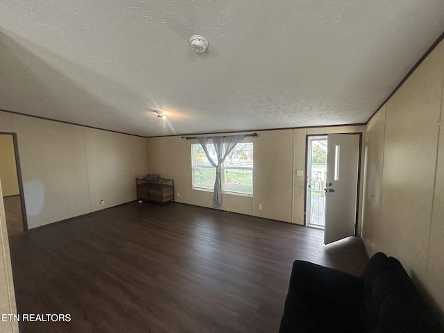 230 Hitch St, Vonore, TN 37885 - unfurnished living room with a textured ceiling, wood finished floors, and ornamental molding
