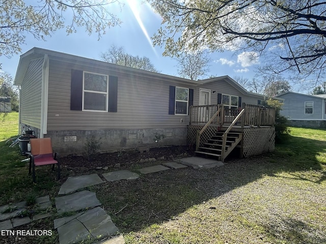 230 Hitch St, Vonore, TN 37885 - manufactured / mobile home featuring crawl space, a front yard, a wooden deck, and stairs