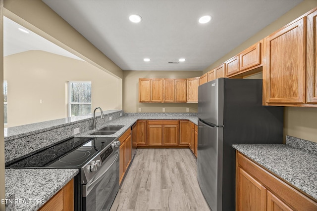 299 Shire Ln, Celina, TN 38551 - kitchen with appliances with stainless steel finishes, a sink, light wood-type flooring, light stone counters, and recessed lighting