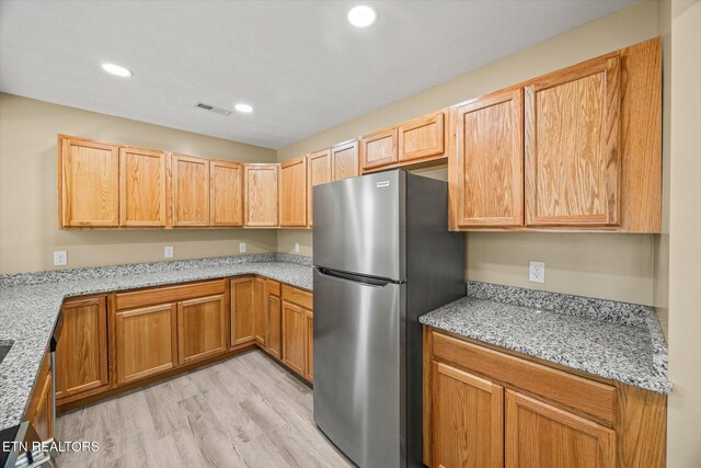 299 Shire Ln, Celina, TN 38551 - kitchen featuring freestanding refrigerator, light wood-type flooring, recessed lighting, and light stone countertops