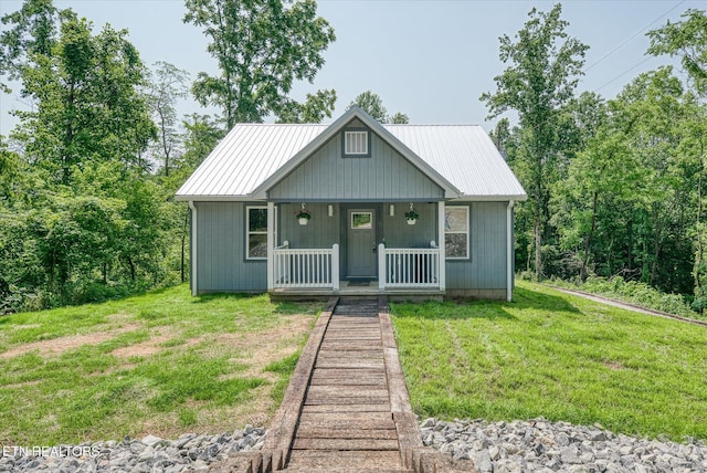 299 Shire Ln, Celina, TN 38551 - view of front of house featuring a porch, a front lawn, and metal roof
