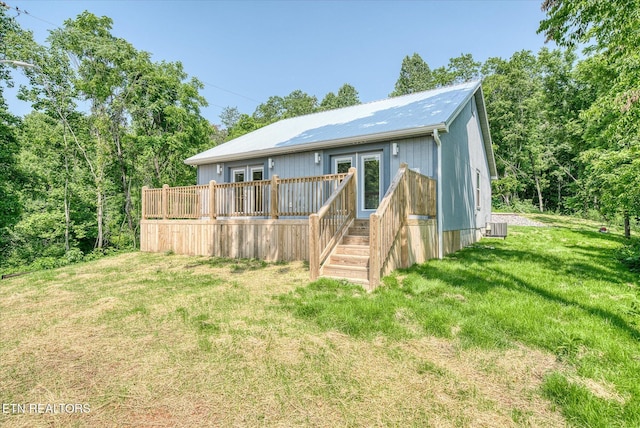 299 Shire Ln, Celina, TN 38551 - view of front facade with a front lawn, french doors, a wooden deck, central AC unit, and metal roof
