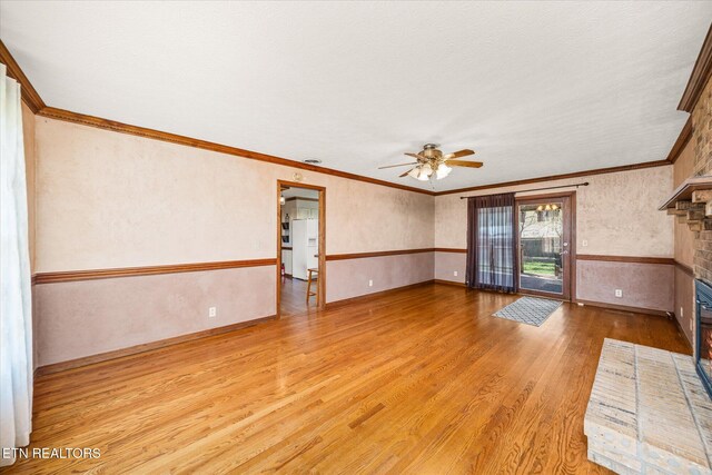 1441 Bunker Hill Rd, Cookeville, TN 38506 - unfurnished living room with a brick fireplace, baseboards, ceiling fan, wood finished floors, and ornamental molding