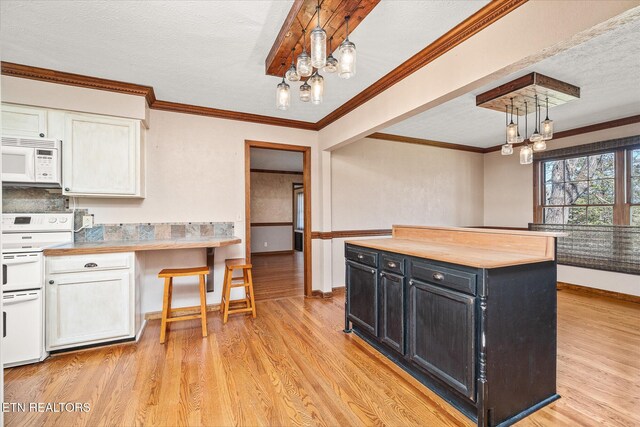1441 Bunker Hill Rd, Cookeville, TN 38506 - kitchen with light wood finished floors, white appliances, dark cabinetry, and an inviting chandelier