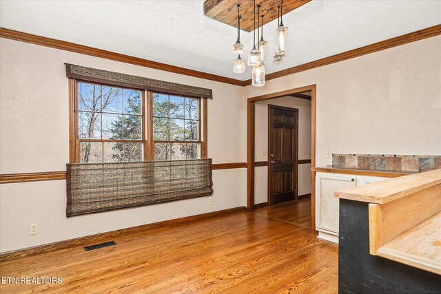 1441 Bunker Hill Rd, Cookeville, TN 38506 - unfurnished dining area featuring wood finished floors, ornamental molding, baseboards, and visible vents
