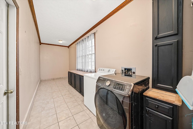 1441 Bunker Hill Rd, Cookeville, TN 38506 - clothes washing area featuring washer and clothes dryer, light tile patterned floors, ornamental molding, baseboards, and cabinet space
