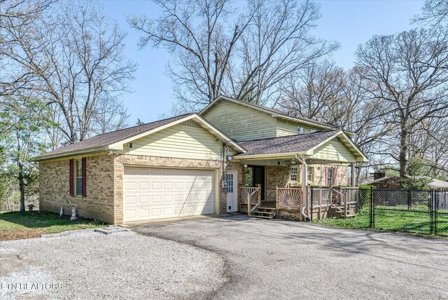 1441 Bunker Hill Rd, Cookeville, TN 38506 - view of front of house with an attached garage, aphalt driveway, fence, and brick siding