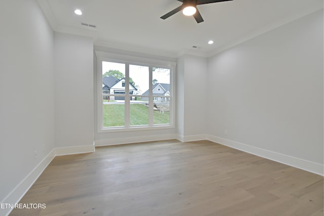 spare room featuring ceiling fan, crown molding, light wood-style flooring, baseboards, and recessed lighting