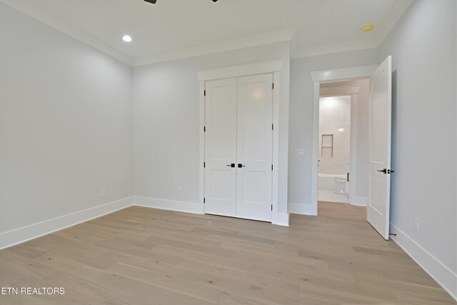 unfurnished bedroom with light wood-style flooring, baseboards, a closet, crown molding, and recessed lighting