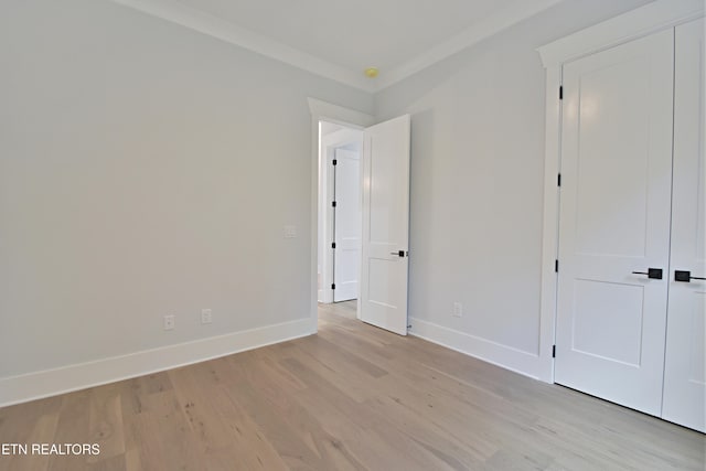 unfurnished bedroom with light wood-style flooring and baseboards