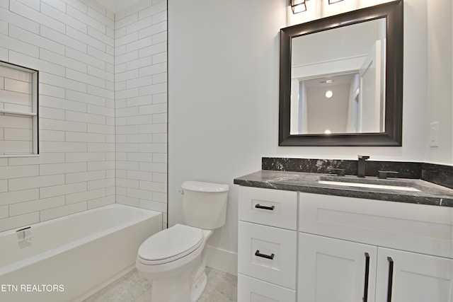 bathroom with toilet, vanity, and baseboards