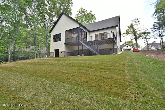 rear view of house with crawl space, a sunroom, stairway, a wooden deck, and a lawn