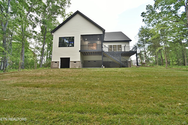 rear view of house with stairway, crawl space, a wooden deck, and a yard