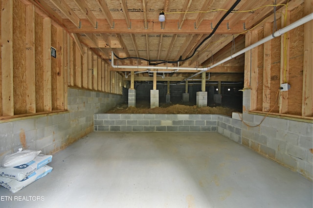 below grade area with concrete block wall