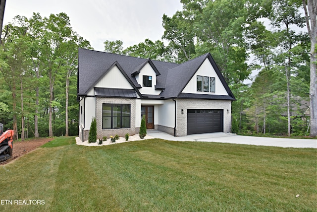 modern farmhouse with brick siding, driveway, a garage, and a front yard