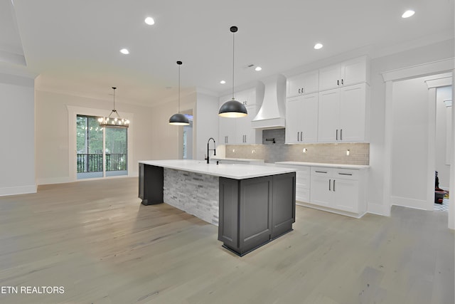 336 Nuhya Ln, Loudon, TN 37774 - kitchen featuring custom range hood, crown molding, light countertops, decorative backsplash, and light wood-style floors