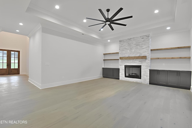 336 Nuhya Ln, Loudon, TN 37774 - unfurnished living room with a raised ceiling, ceiling fan, light wood-type flooring, baseboards, and a fireplace