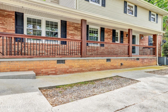 exterior space with brick siding and covered porch