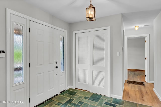 foyer entrance with plenty of natural light and baseboards