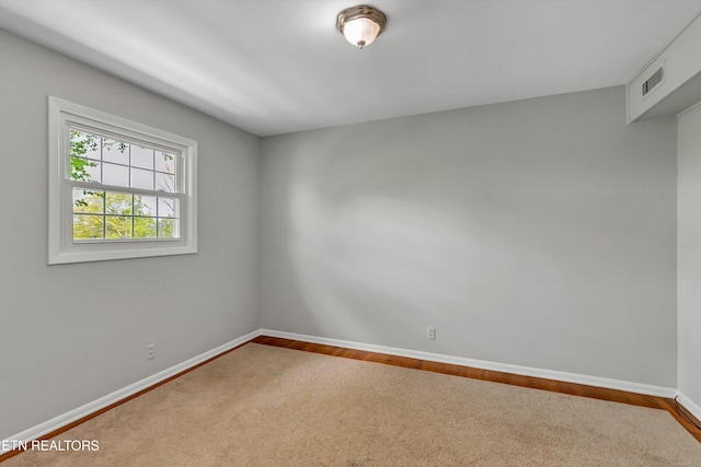 spare room with visible vents and baseboards