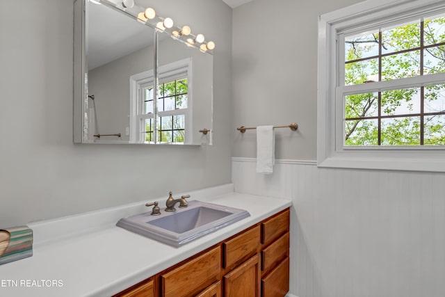 bathroom featuring a wainscoted wall and vanity