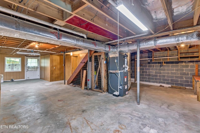 below grade area with heating unit and stairway