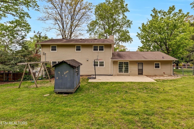 back of property featuring a storage shed, a chimney, a fenced backyard, an outdoor structure, and a patio