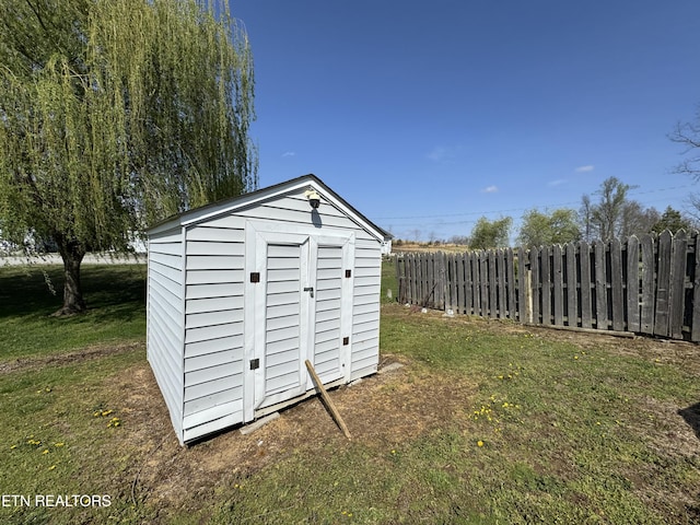 view of shed featuring fence