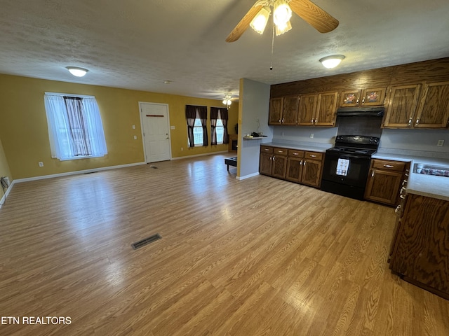 kitchen with under cabinet range hood, ceiling fan, visible vents, and black range with electric cooktop