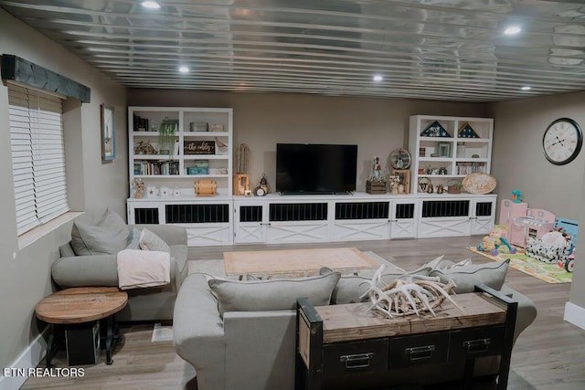 living area featuring wood finished floors and recessed lighting