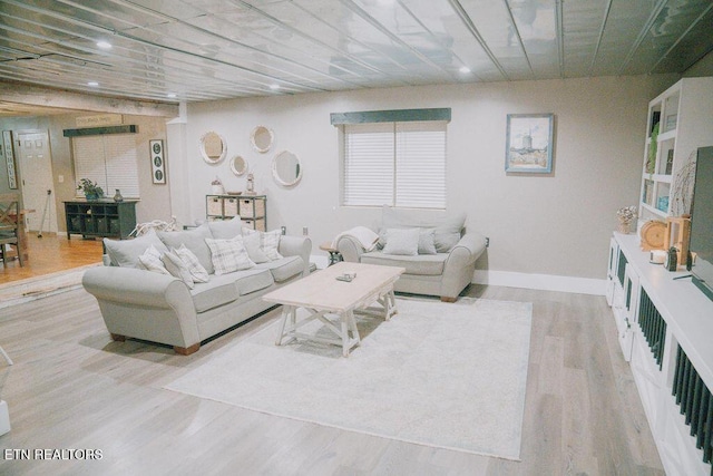 living area featuring baseboards and wood finished floors