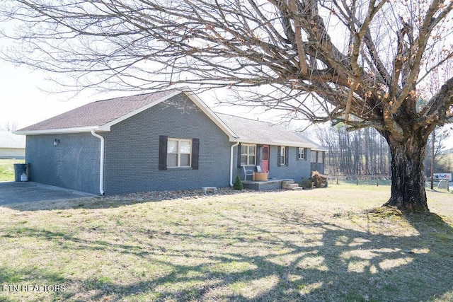 view of front of property with brick siding and a front lawn