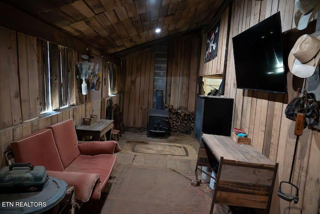 interior space with wooden walls and a wood stove
