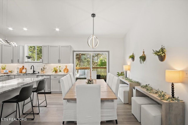 dining space featuring recessed lighting and light wood-style floors
