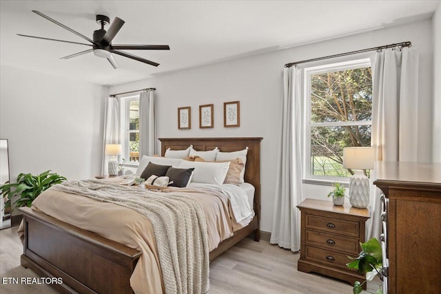 bedroom with light wood finished floors and a ceiling fan