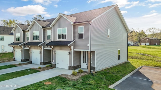 townhome / multi-family property featuring a garage, a front lawn, and concrete driveway