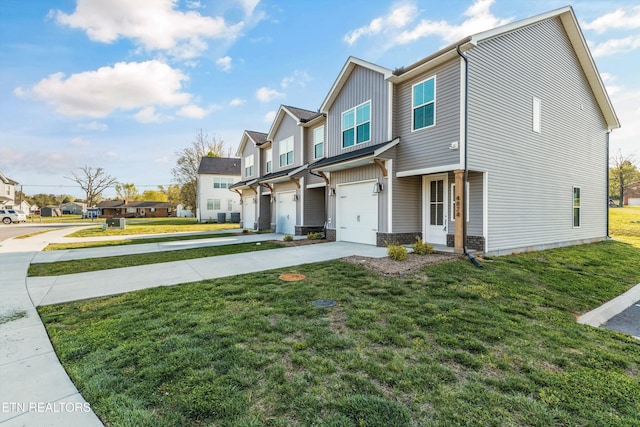 view of front facade with a front lawn, driveway, a residential view, and board and batten siding