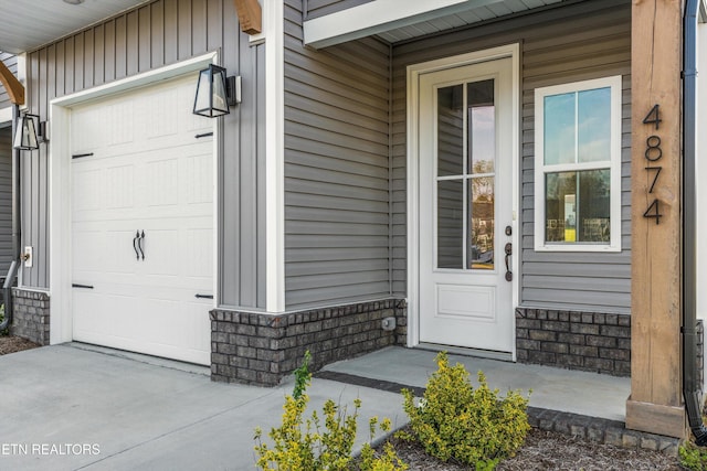 property entrance featuring an attached garage