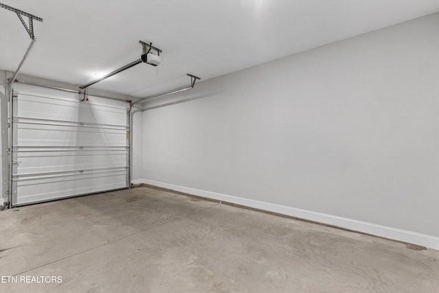 garage featuring baseboards and a garage door opener