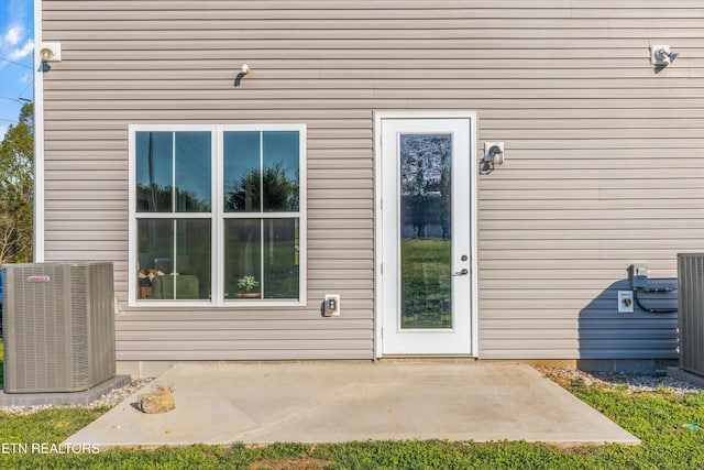 doorway to property with a patio and central AC unit