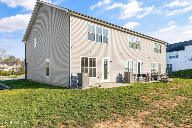 back of property with a yard, central AC, and a patio