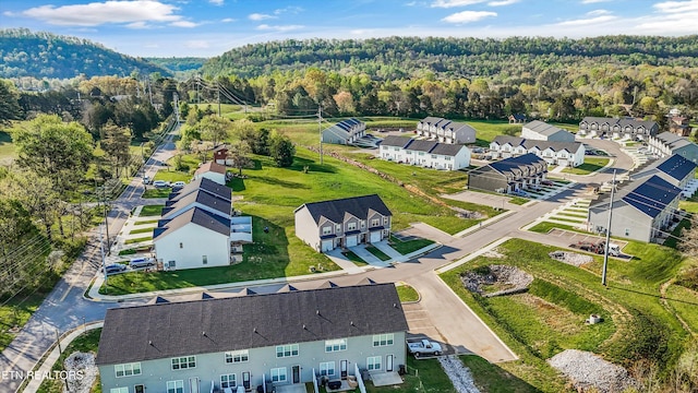 drone / aerial view featuring a forest view and a residential view