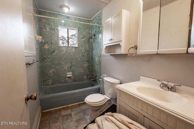 bathroom with vanity, toilet, stone finish flooring, and bathtub / shower combination