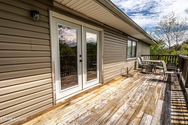 wooden terrace with outdoor dining space