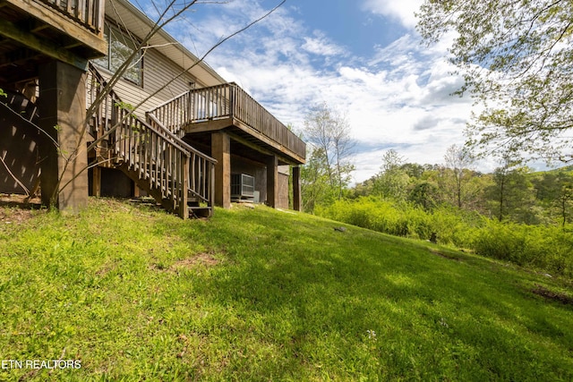 view of yard featuring a wooden deck and stairs
